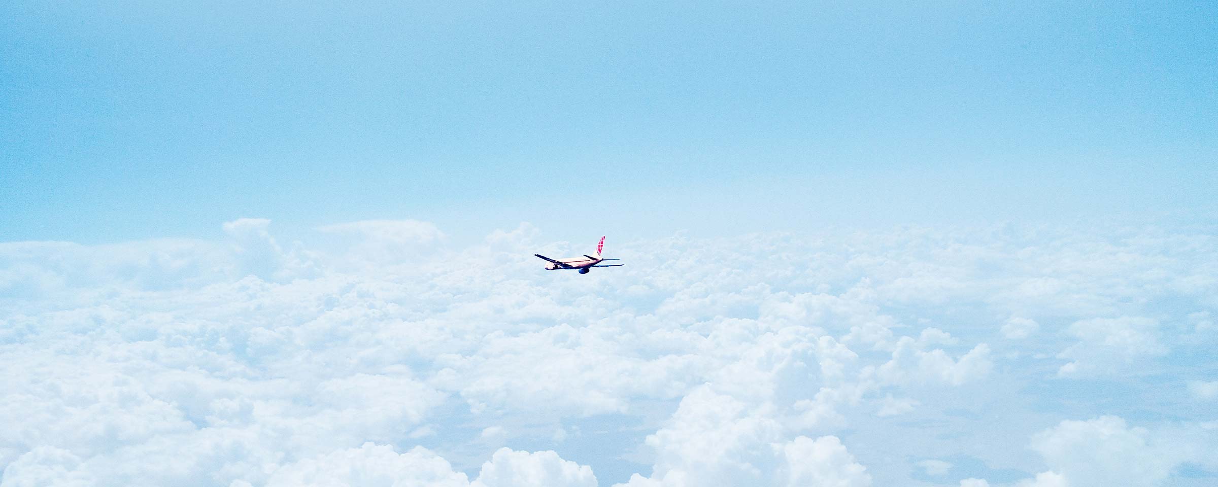 Airplane flies above clouds