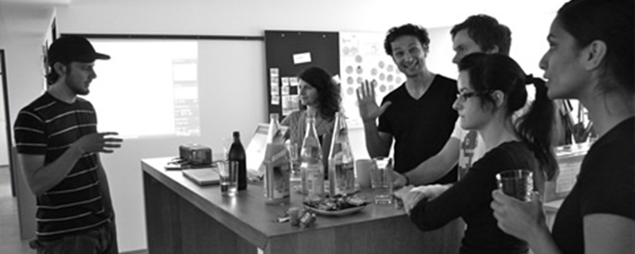 Intuity employees are standing around a table and talking to each other